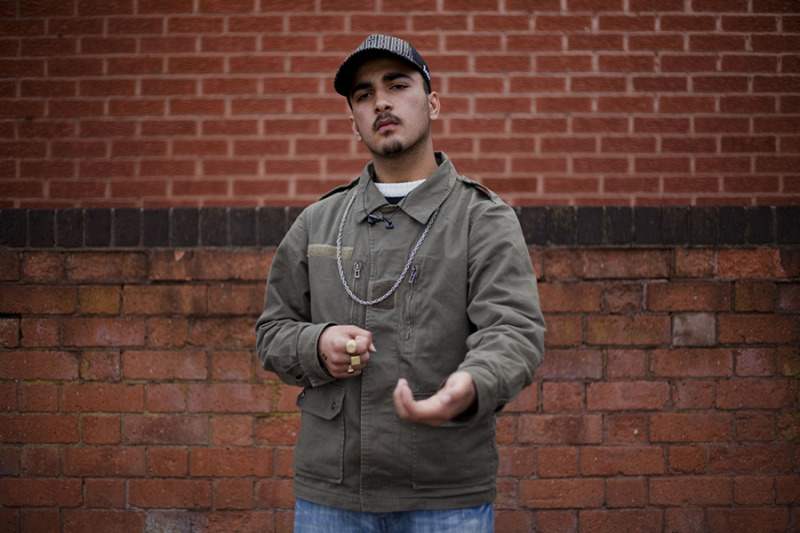 2.-Brick-wall-cap-and-invisible-gun-©-Mahtab-Hussain-You-Get-Me-900x600