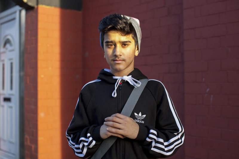 Young boy in pink and grey beanie © Mahtab Hussain