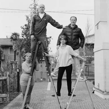The Agostini family climb a set of ladders.