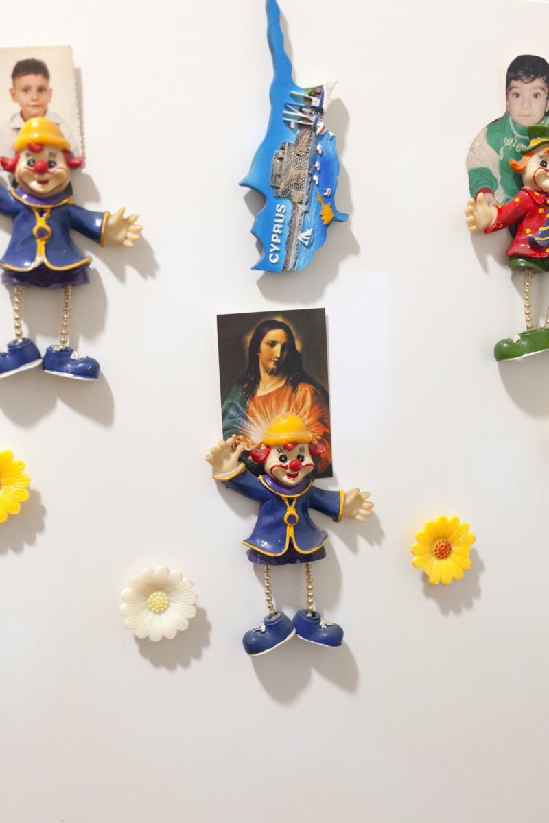 A small thumbnail devotional image of Christ held in place by tacky fridge magnets.
