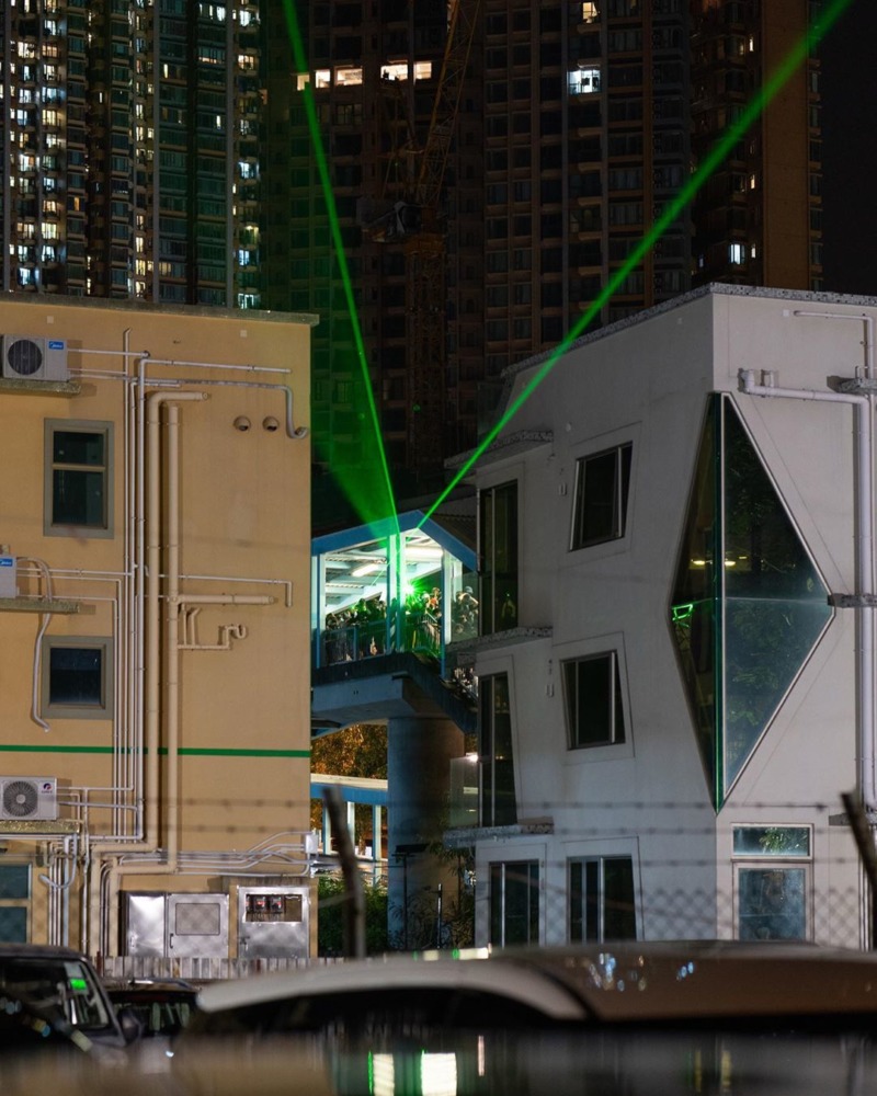 Laser beams shoot out of buildings, lighting up the streets of Hong Kong.