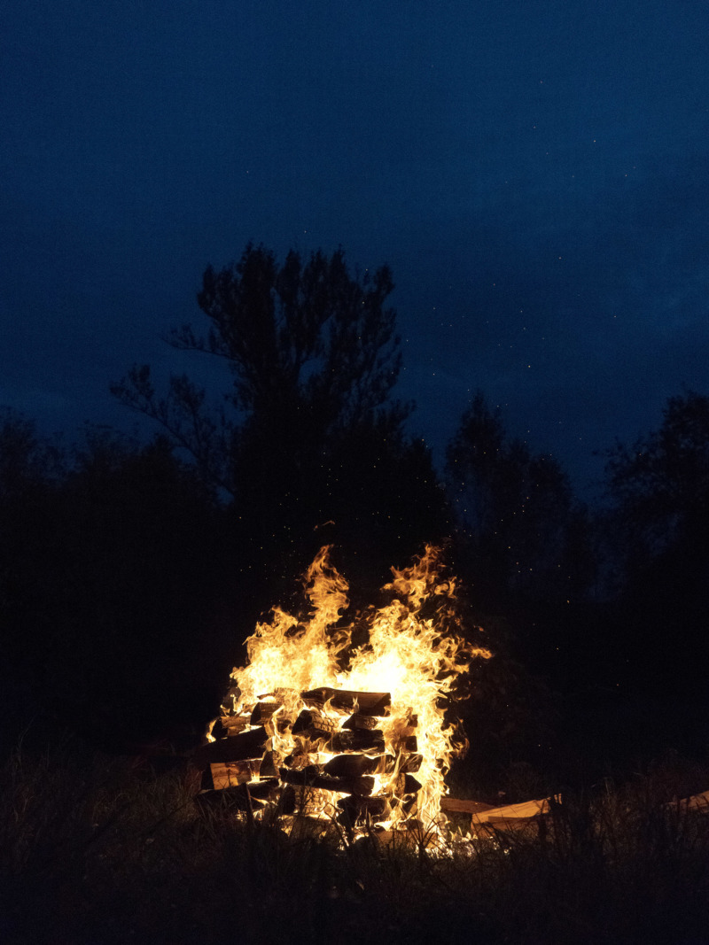 A log pyre burns in the dead of night.